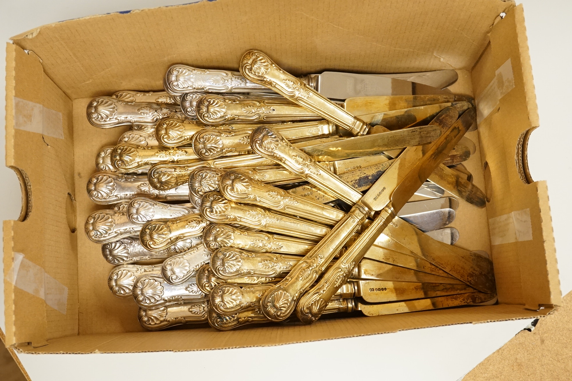 A set of eighteen William IV silver gilt King's pattern dessert knives, William Eaton, London, 1831/2, loaded handles, together with a set of twelve silver handled Kings pattern table knives and twelve matching dessert k